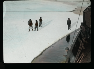 Image of Men by rail of vessel, others on ice